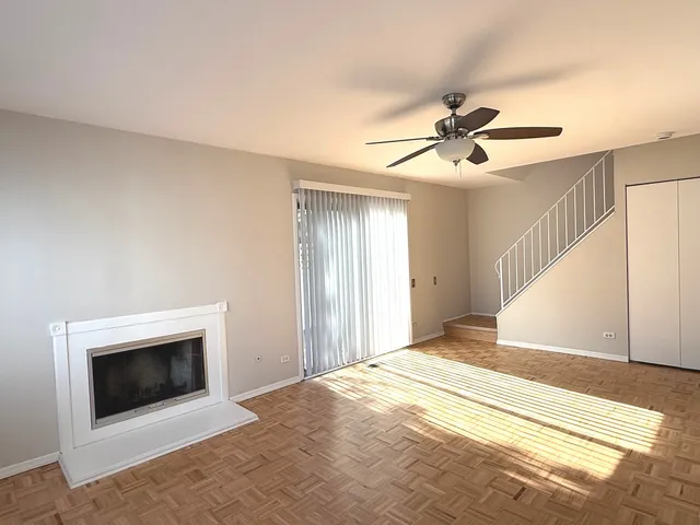 a bedroom with a bed and a ceiling fan