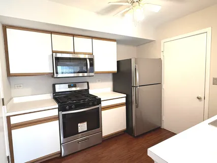 a kitchen with a refrigerator stove and microwave