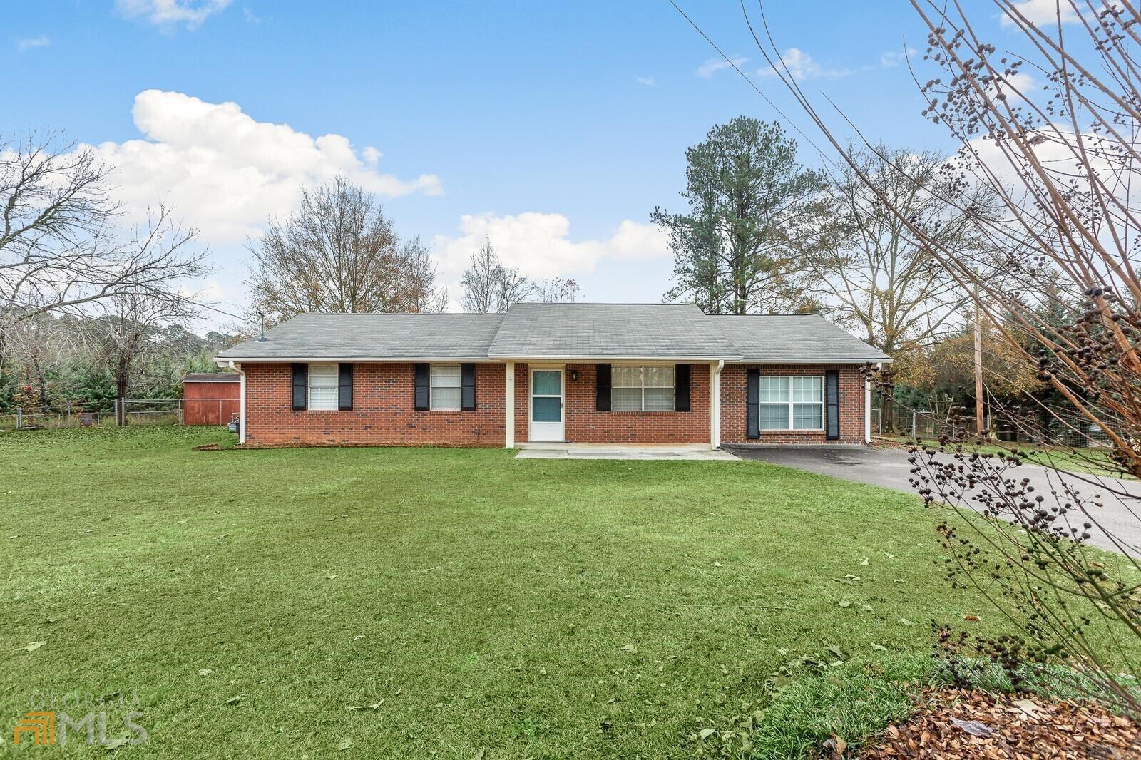 1608 Welcome Road Newnan, GA 30263 - Photo 1 of 1 a view of a yard in front of a house with large trees