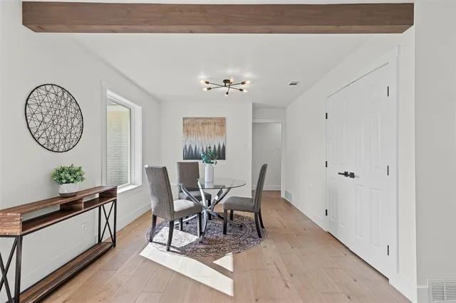 a view of a dining room with furniture and a chandelier