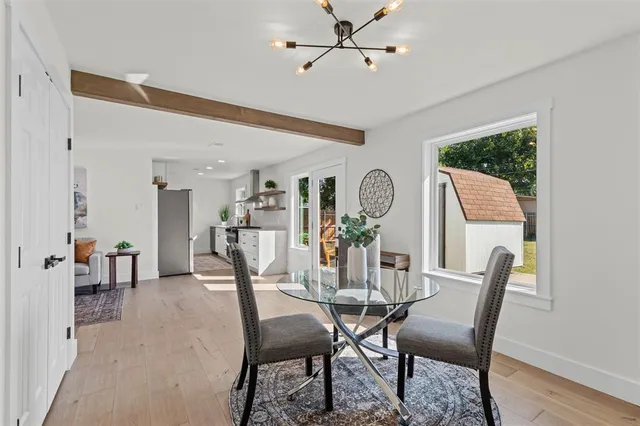 a view of a dining room with furniture and a potted plant
