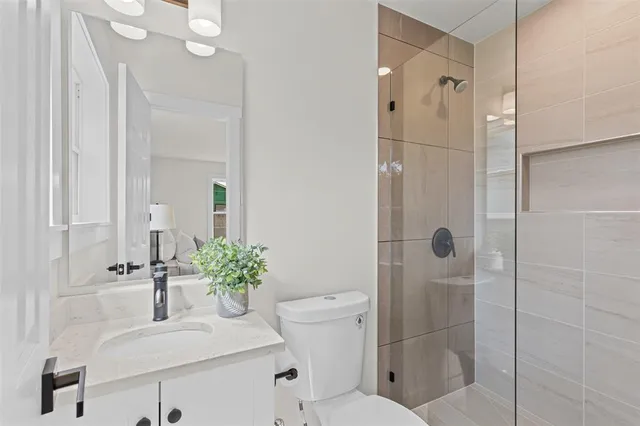 a bathroom with a sink toilet and shower