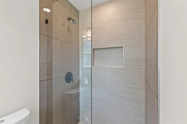 a bathroom with a shower and toilet