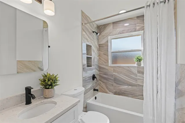 a bathroom with a shower curtain and a sink