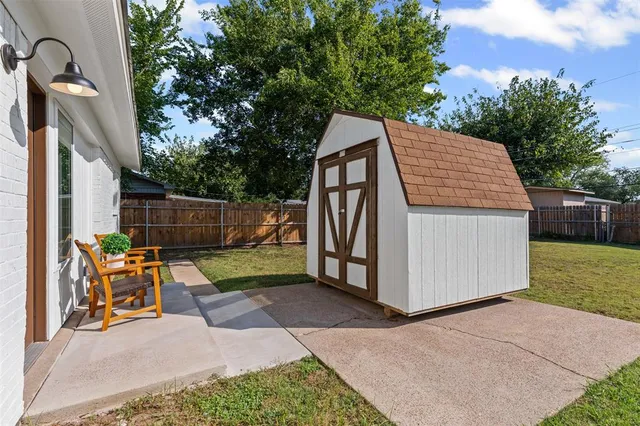 a view of backyard with wooden fence and large trees