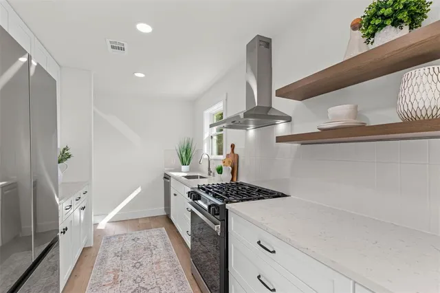 a kitchen with a stove and a sink
