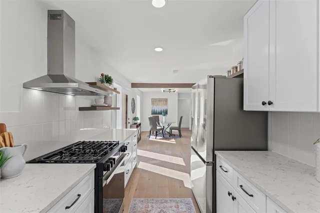 a kitchen with a stove and a refrigerator