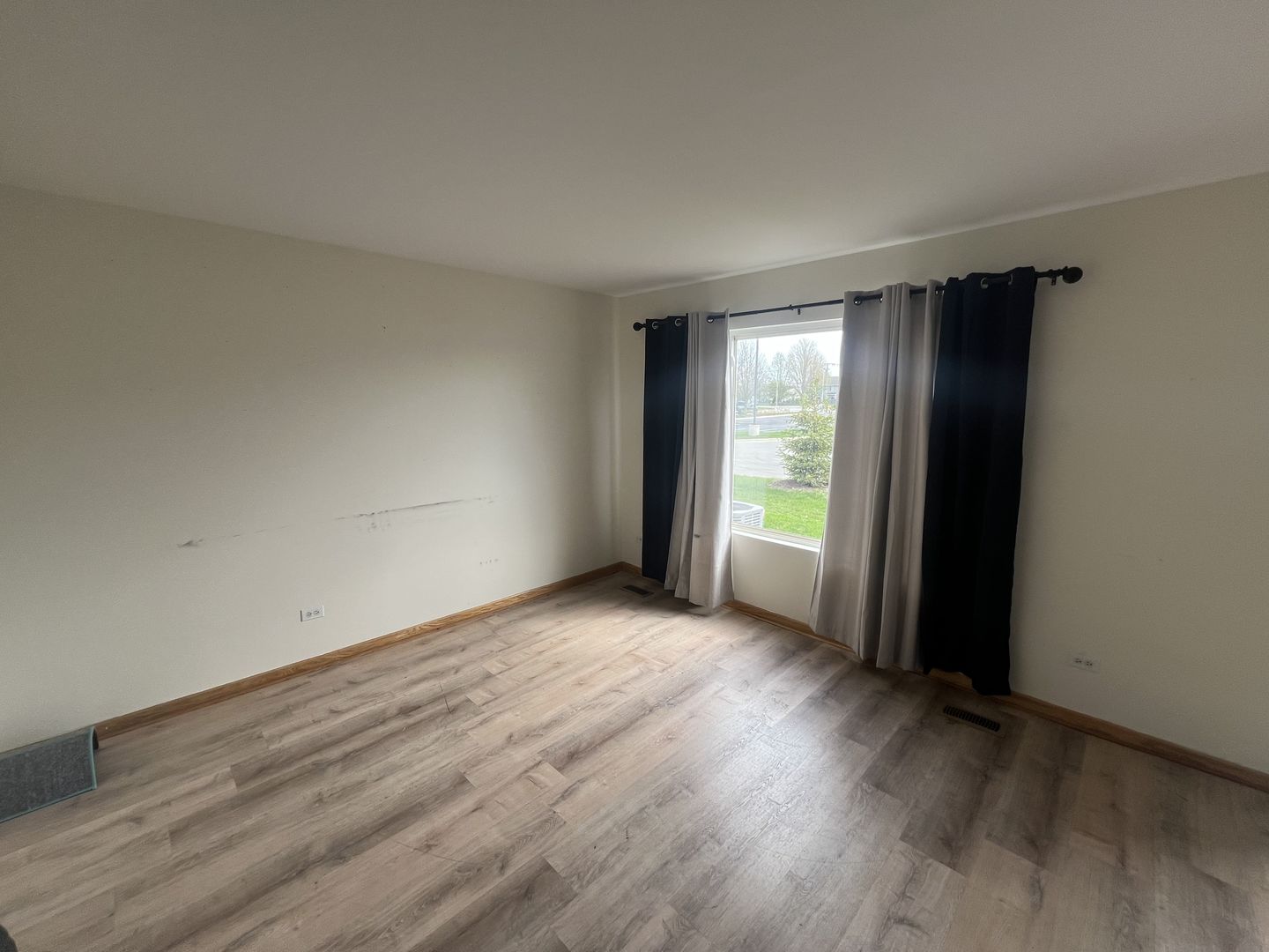 506 Prairie View Drive, Unit 506 Minooka, IL 60447 - Photo 4 of 12 an empty room with wooden floor and windows