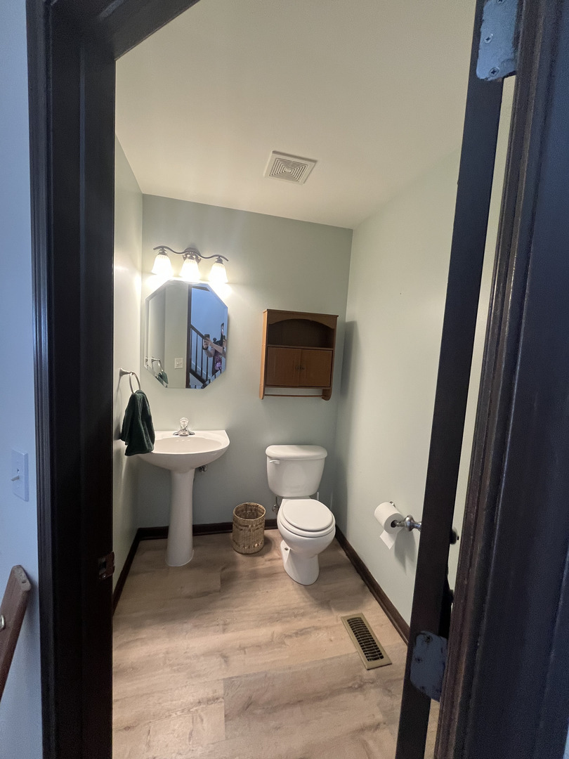 506 Prairie View Drive, Unit 506 Minooka, IL 60447 - Photo 5 of 12 a bathroom with a sink toilet a mirror and shower