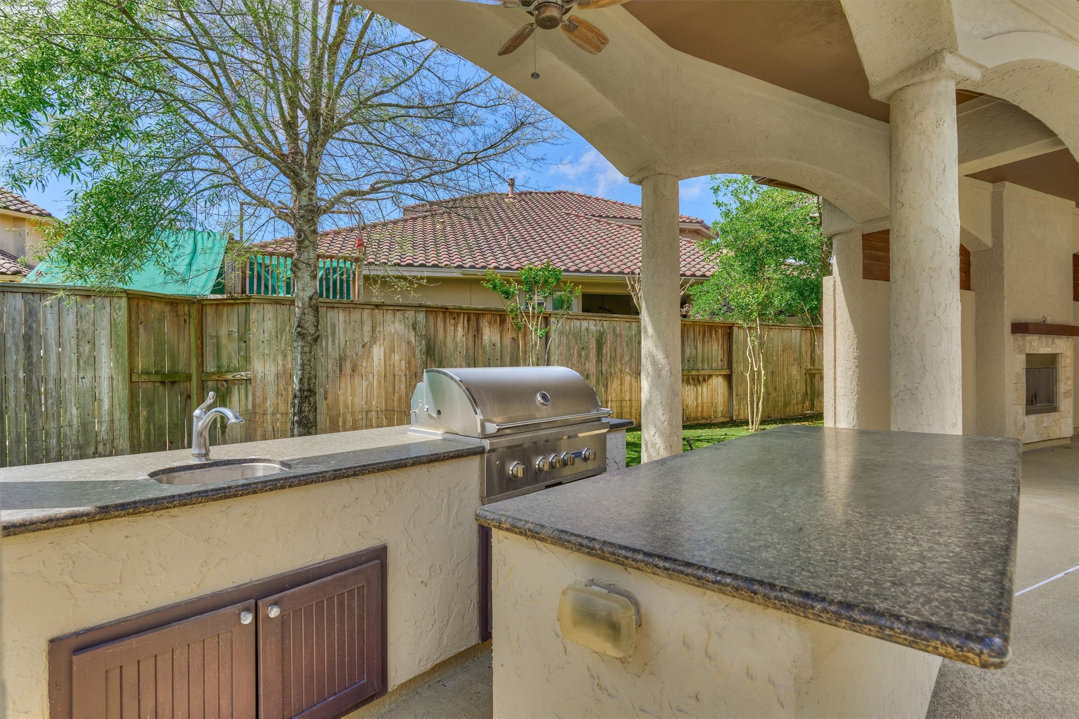 25 Post Shadow Estate Drive Spring, TX 77389 - Photo 46 of 49 Entertain outdoors with a covered patio, built-in grill station, sink, and spacious stone counters.