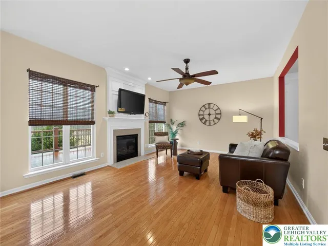 a living room with furniture a fireplace and a flat screen tv