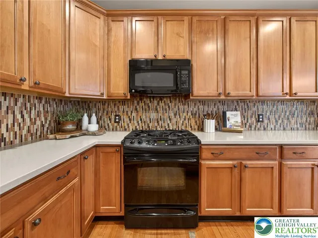 a kitchen with granite countertop a sink a stove and cabinets