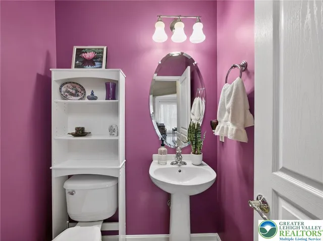 a bathroom with a sink mirror and toilet