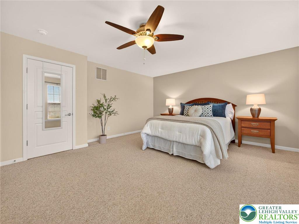 8611 Cascade Road Breinigsville, PA 18031 - Photo 29 of 40 a bedroom with a bed and a chandelier