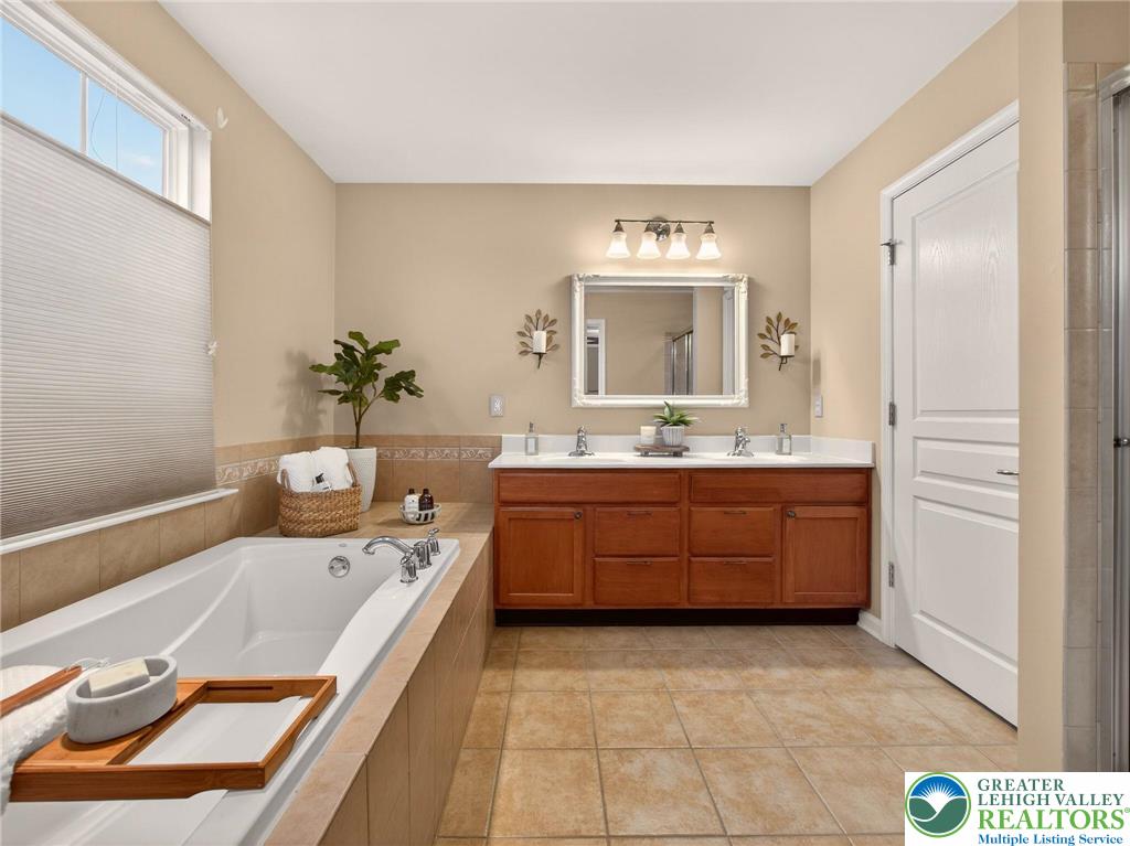 8611 Cascade Road Breinigsville, PA 18031 - Photo 30 of 40 a bathroom with a tub sink and mirror