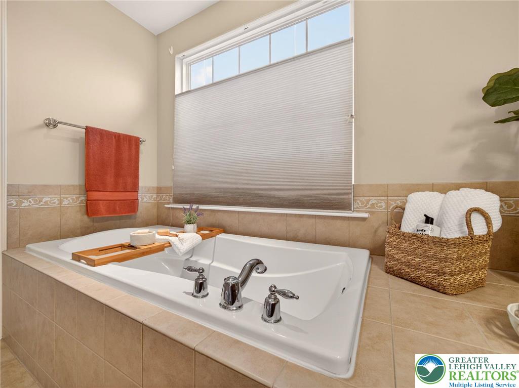 8611 Cascade Road Breinigsville, PA 18031 - Photo 32 of 40 a bathroom with a tub sink and mirror