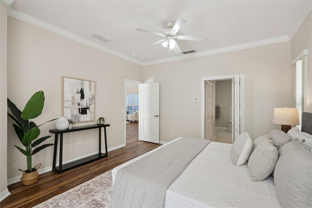 3441 Hickory Creek Road Deltona, FL 32738 - Photo 13 of 62 a bedroom with a bed chandelier and a window