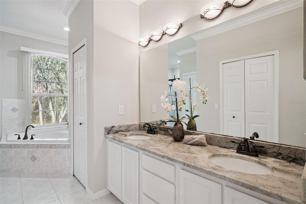 3441 Hickory Creek Road Deltona, FL 32738 - Photo 17 of 62 a bathroom with a granite countertop sink and a mirror