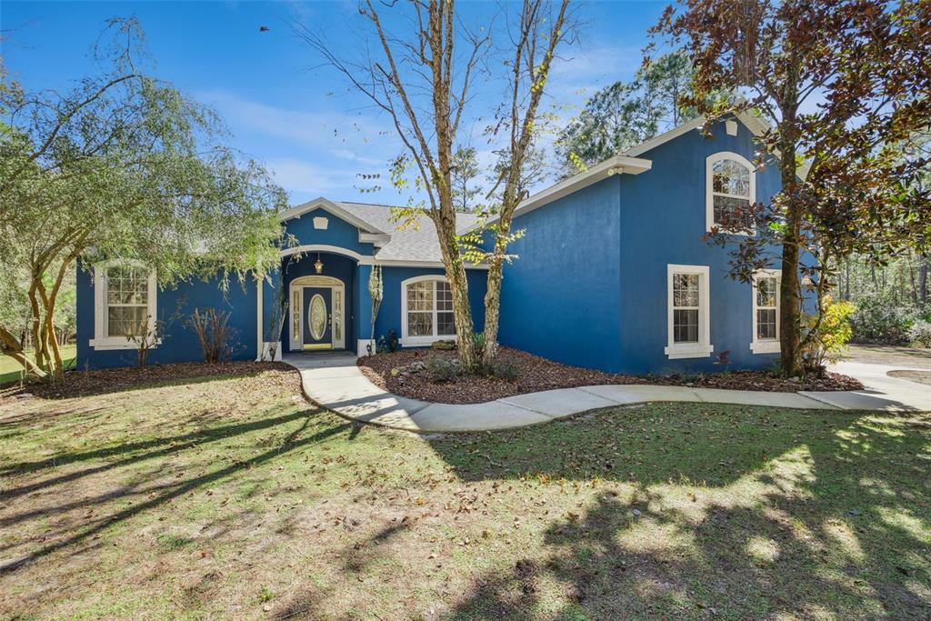 3441 Hickory Creek Road Deltona, FL 32738 - Photo 2 of 62 a front view of a house with garden