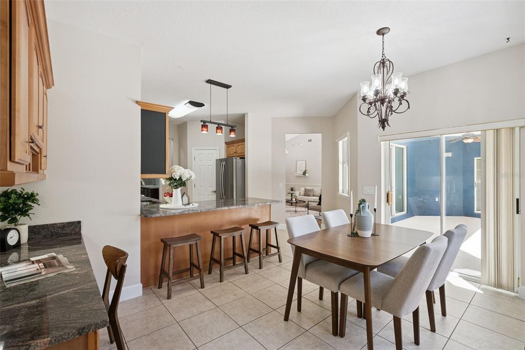 3441 Hickory Creek Road Deltona, FL 32738 - Photo 26 of 62 a view of a dining room with furniture and chandelier