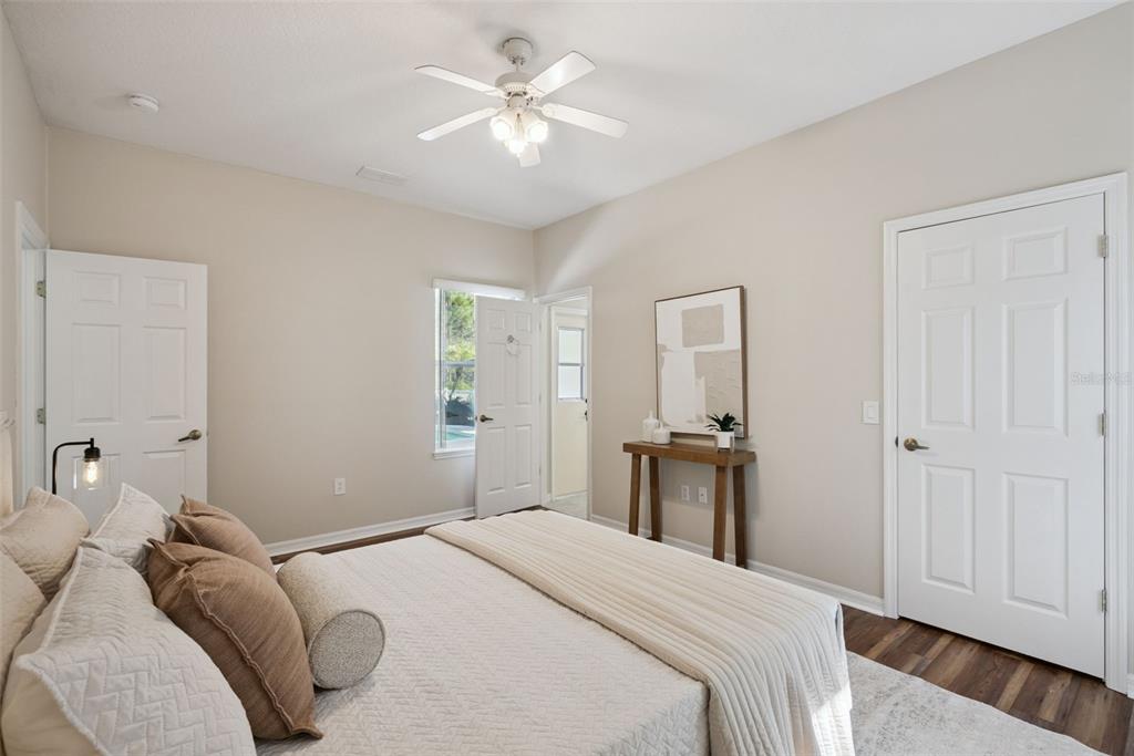 3441 Hickory Creek Road Deltona, FL 32738 - Photo 29 of 62 a bedroom with a bed and a chandelier