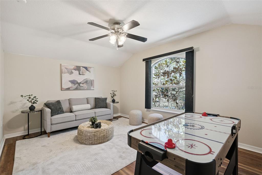 3441 Hickory Creek Road Deltona, FL 32738 - Photo 32 of 62 a living room with furniture and a large window