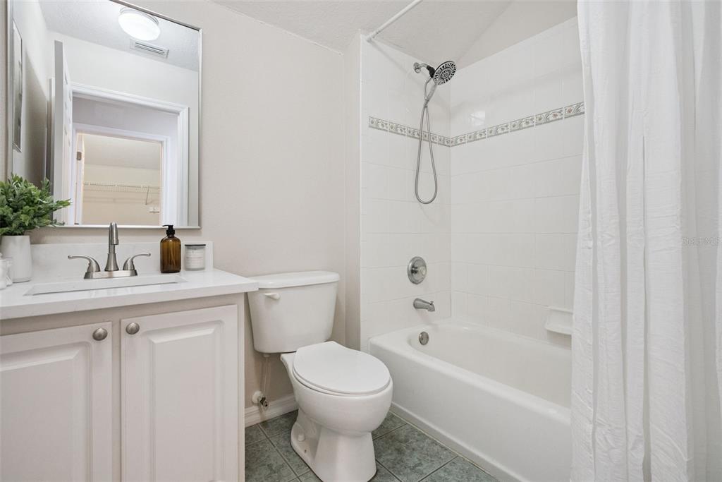 3441 Hickory Creek Road Deltona, FL 32738 - Photo 34 of 62 a bathroom with a sink a toilet and shower