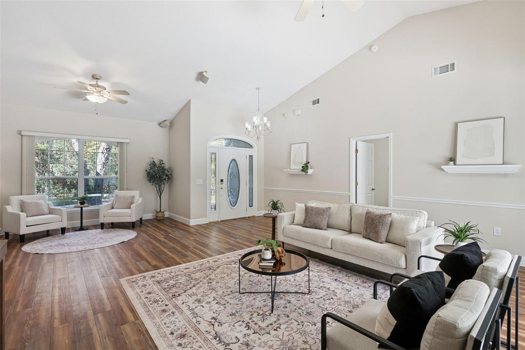 3441 Hickory Creek Road Deltona, FL 32738 - Photo 7 of 62 a living room with furniture or couch and a large window