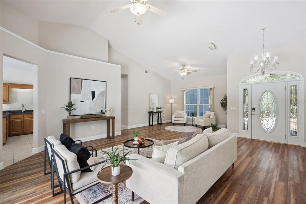 3441 Hickory Creek Road Deltona, FL 32738 - Photo 10 of 62 a living room with furniture a fireplace and a chandelier