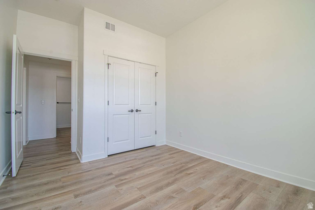 4276 South Main Street, Unit 303 Murray, UT 84107 - Photo 12 of 20 Room featuring light wood-finish flooring, white walls, and white baseboards