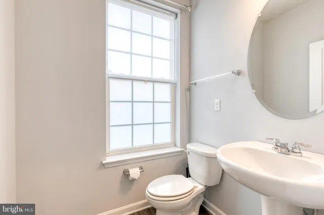 a white toilet sitting next to a bathroom sink