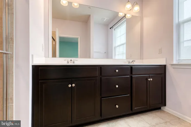 a bathroom with a sink vanity and mirror