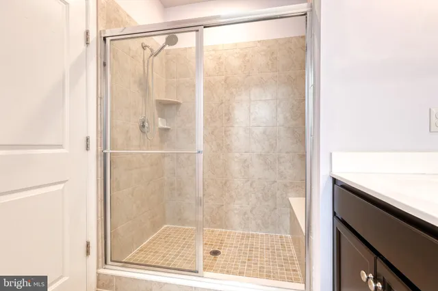 a bathroom with a glass shower door