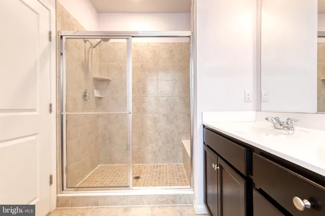 a bathroom with a shower and a sink