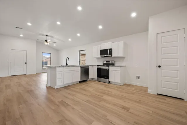 a view of kitchen with microwave and cabinets