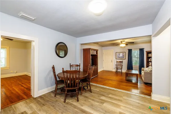 a dining room with furniture and window