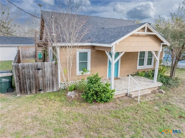 a view of a house with a yard and plants