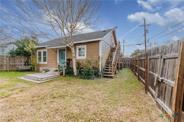 a view of a house with backyard and porch