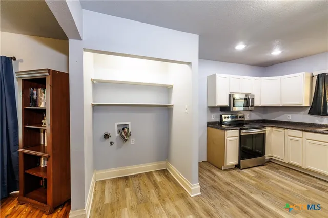 a kitchen with granite countertop a stove and a refrigerator