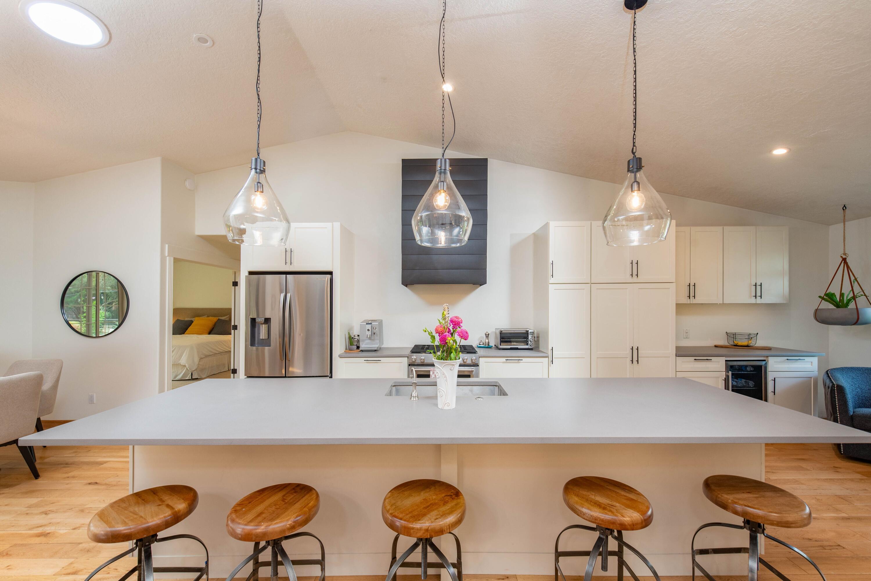 2701 Northwest Strath Way Bend, OR 97703 - Photo 12 of 41 The kitchen island is a perfect gathering spot with plenty of seating.