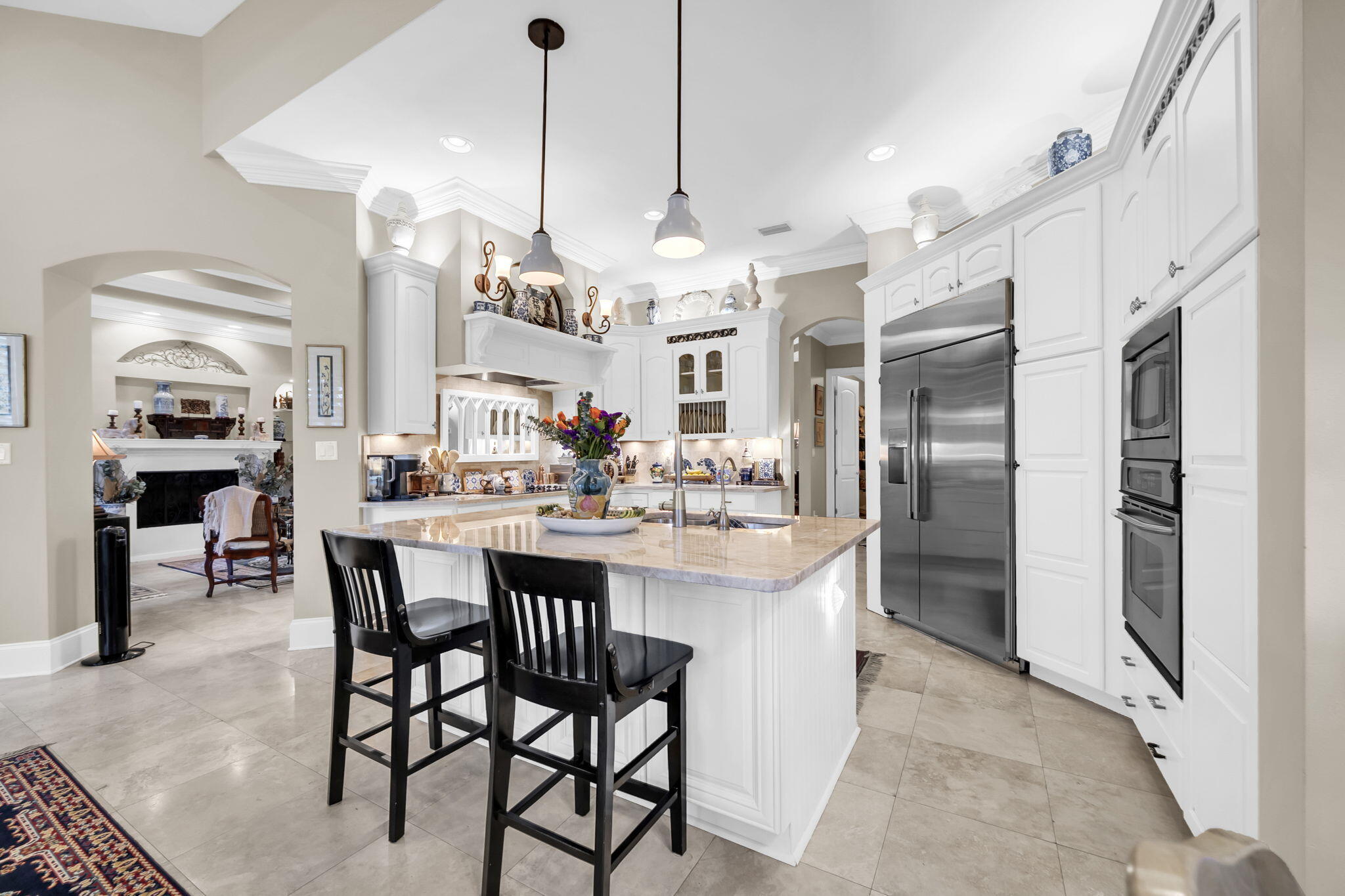 4470 Stonebridge Road Destin, FL 32541 - Photo 29 of 114 a kitchen with stainless steel appliances kitchen island granite countertop a table chairs and a chandelier