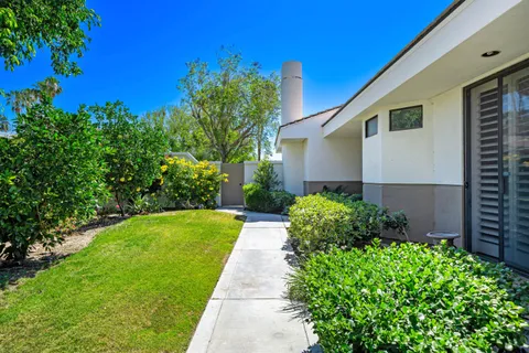 a front view of a house with garden