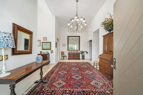 a spacious bedroom with a bed and a chandelier