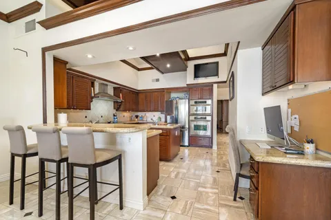a kitchen with stainless steel appliances kitchen island granite countertop a sink and cabinets