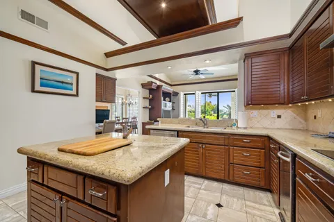a kitchen with granite countertop a sink and cabinets