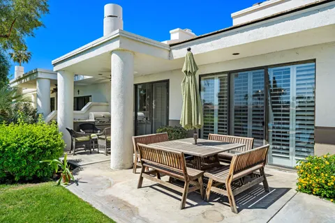 a outdoor space with a table and chairs