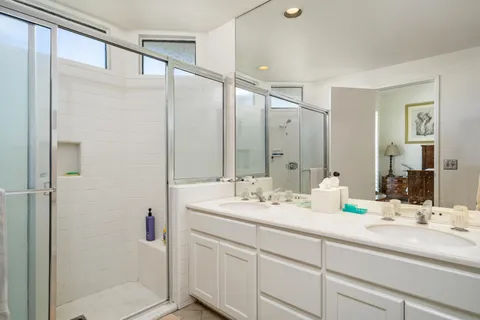 a bathroom with a double vanity sink and mirror