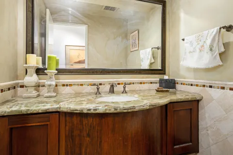 a bathroom with a granite countertop sink a mirror and a