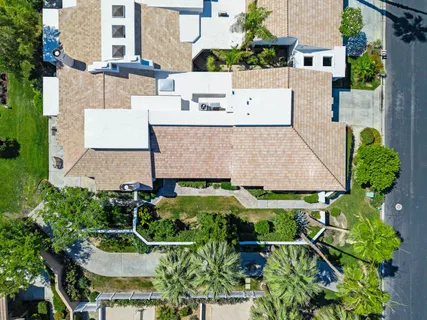 an aerial view of a house with a yard