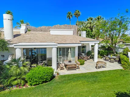a view of a house with garden and a patio